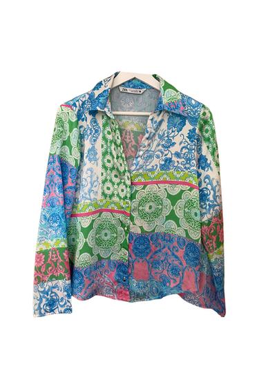 Front view of a multicoloured shirt with a floral print in blue, green, and pink, featuring a classic collar and a front button fastening.