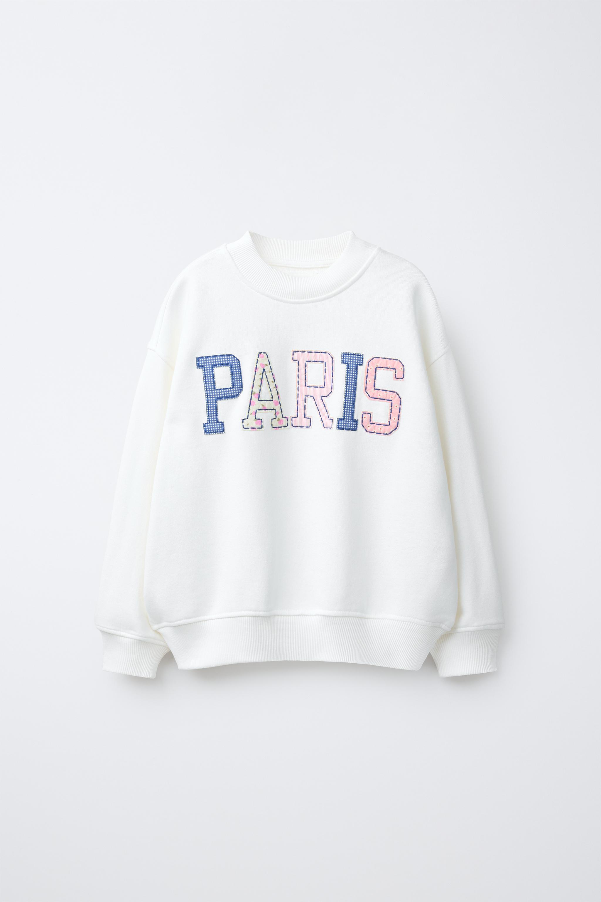 SWEAT AVEC PIÈCES ET INSCRIPTION