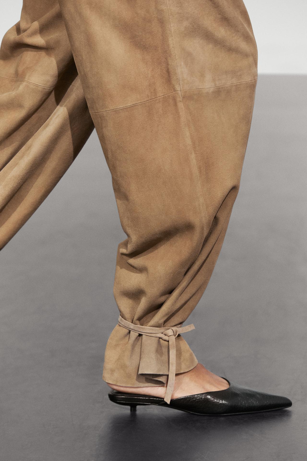Suede pants with tie-hem detail — 553