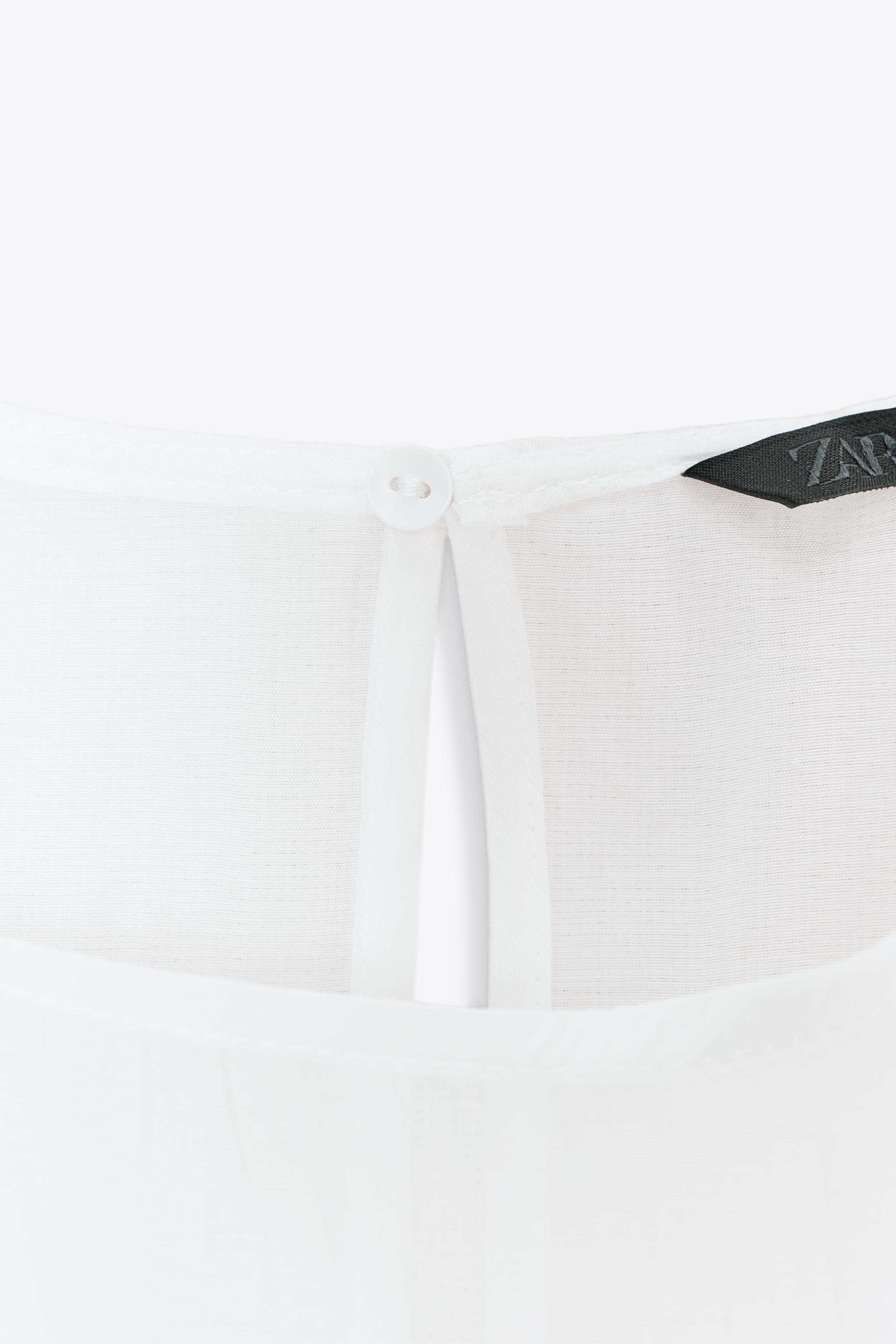 BLOUSE SEMI-TRANSPARENTE À VOLANTS