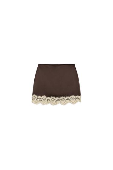 Front view of dark brown culottes with a beige lace hem and a concealed side zip fastening.