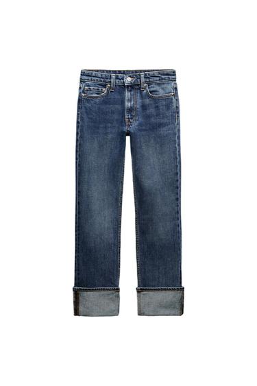 Front view of blue denim jeans with a turned-up hem and front pockets.