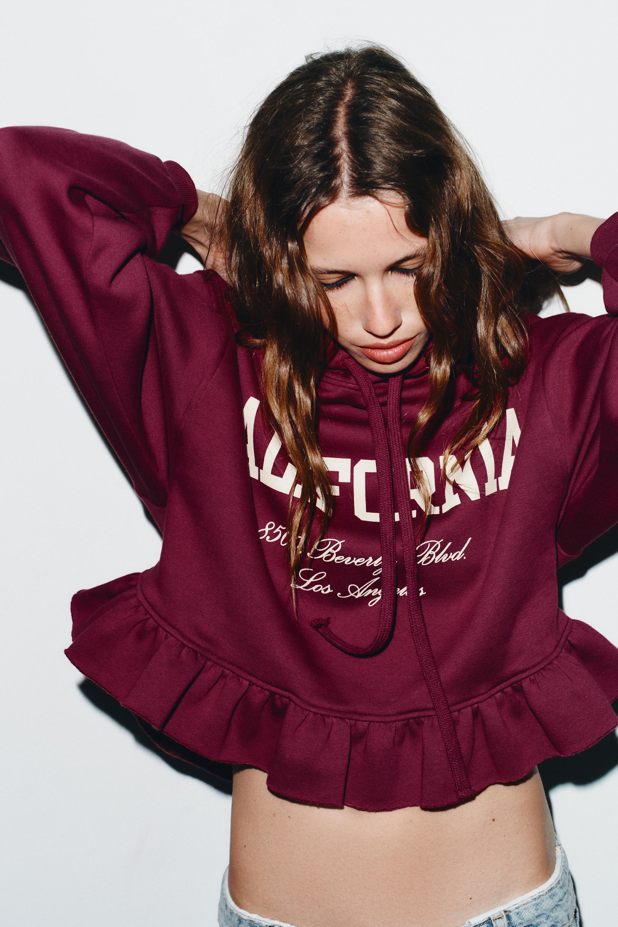 RUFFLED VARSITY SWEATSHIRT