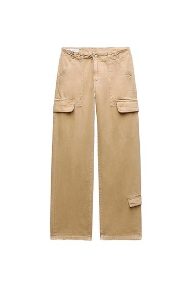 Beige cargo pants with large pockets and button closure, displayed on a white background.