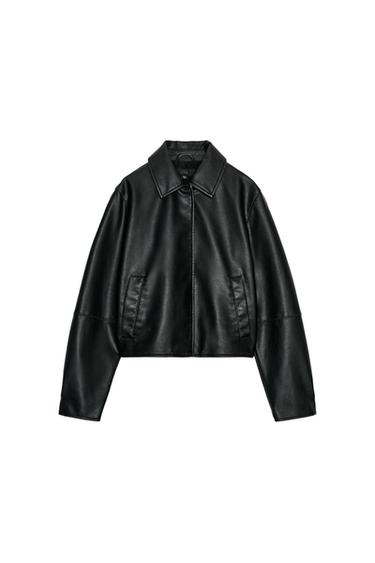 Front view of a black jacket with a shirt collar, long sleeves, and front jetted pockets. Front fastening with concealed buttons.