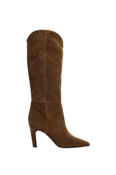 Side view of a brown high-heeled boot, with a pointed toe and visible stitching.