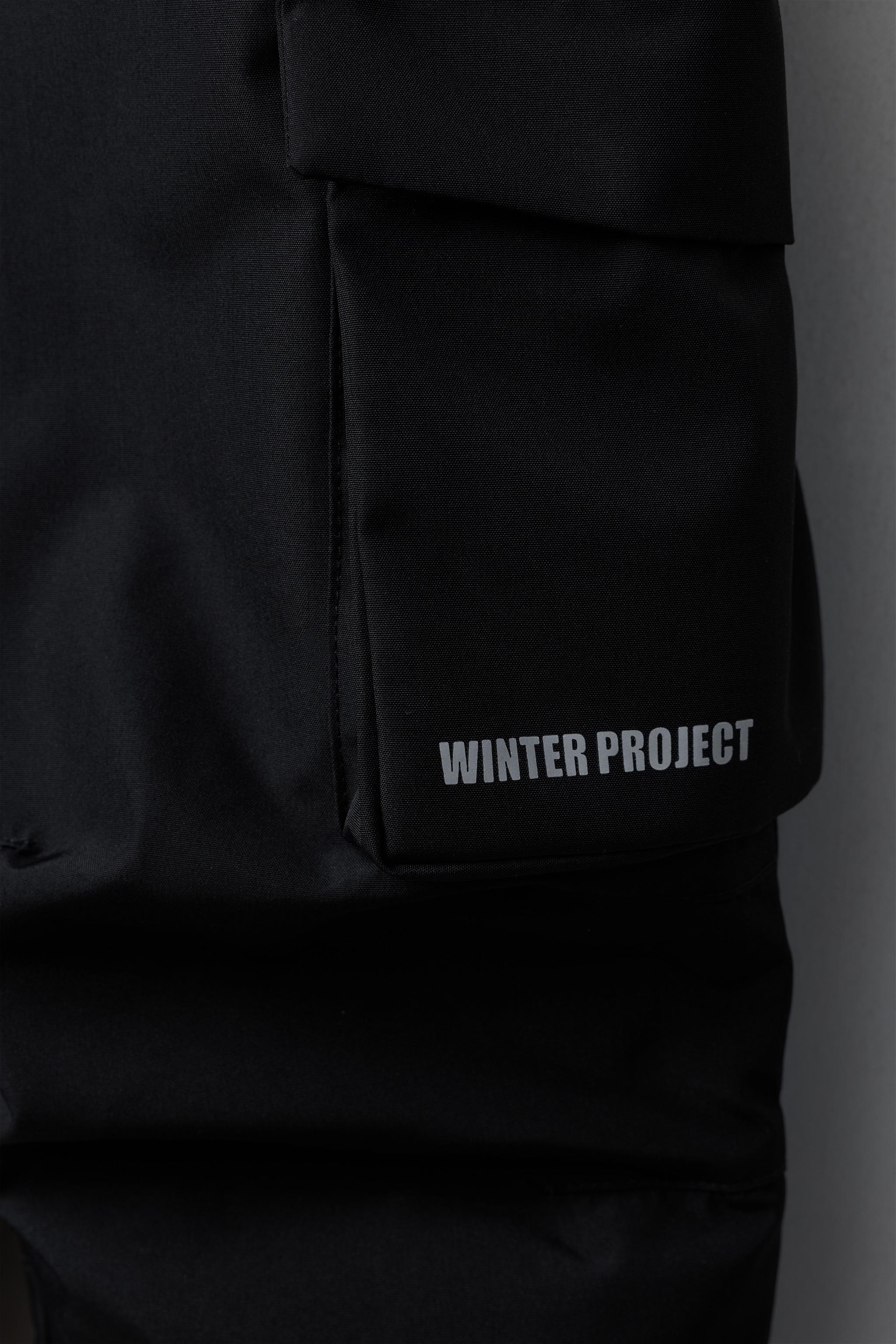 SALOPETTE LONGUE RÉSISTANTE À L'EAU ET AU VENT AVEC POCHES