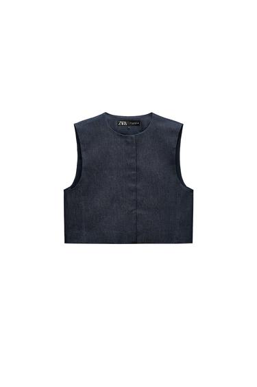 Front view of a navy sleeveless top with a crew neck and concealed front fastening.