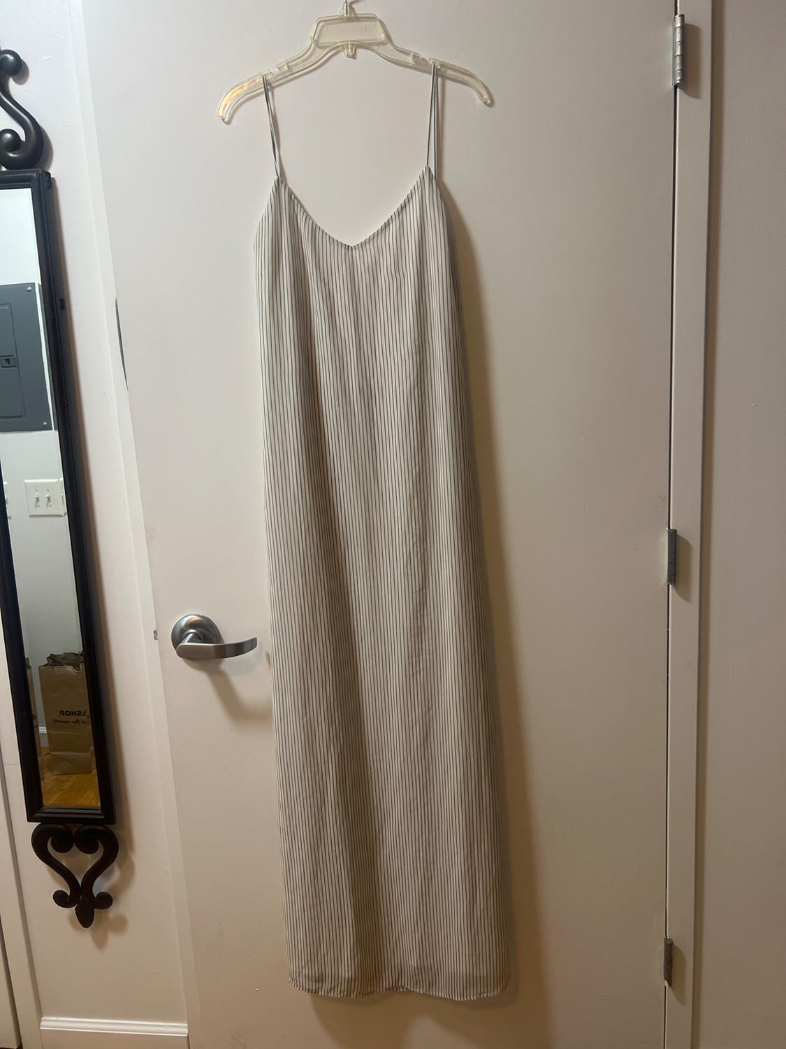 Front view of a long, thin-striped dress with thin straps.