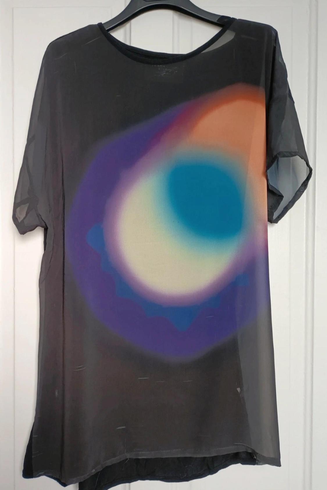 Front view of black blouse with abstract colourful circle print.