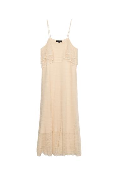 Front view of beige dress with spaghetti straps and ruffles on the chest.