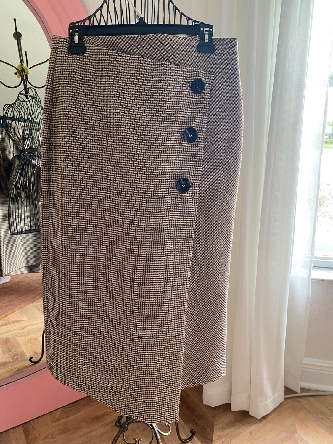 Front view of plaid skirt with large buttons on the side