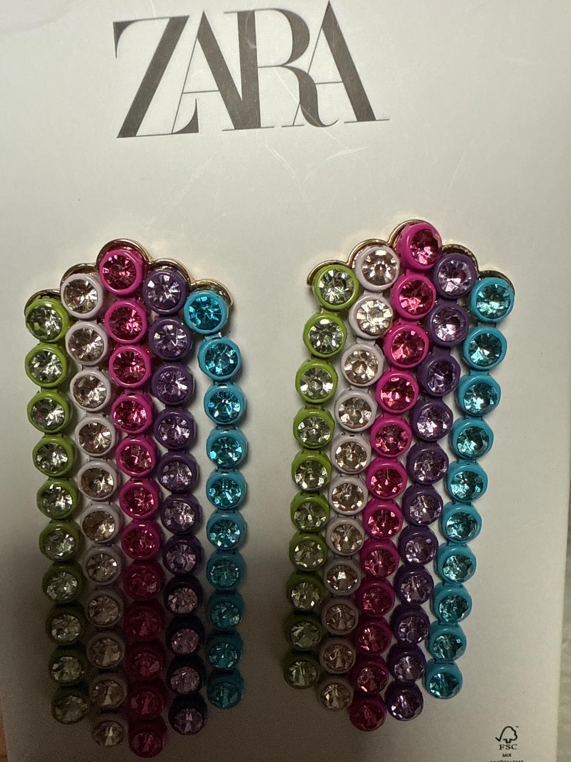 Brightly colored earrings on a white background with the ZARA logo at the top.