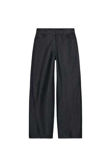 Front view of gray denim pants with a mid-rise, waistband with belt loops, five pockets, and front pleat. Zipper and button closure.