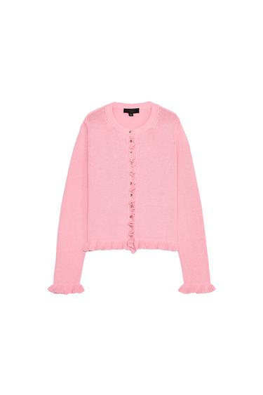 Front view of a pink cardigan with buttons and frills on the trim and long sleeves.