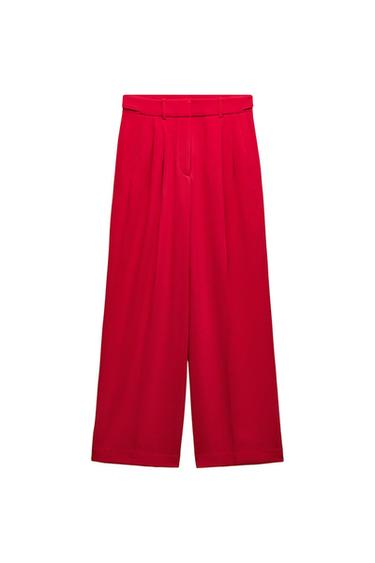 Red wide-leg trousers with pleats and a waistband, white background.
