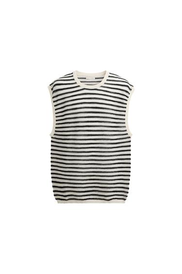 Front view of a black and white striped vest, sleeveless, with a round neck.