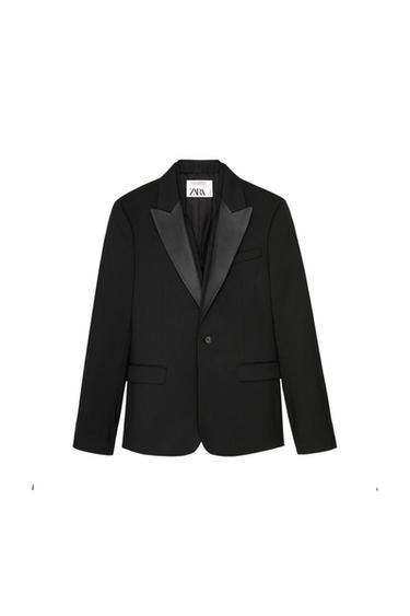 Black jacket with satin lapels and one button, on a white background. Visible label with the text "ZARA".