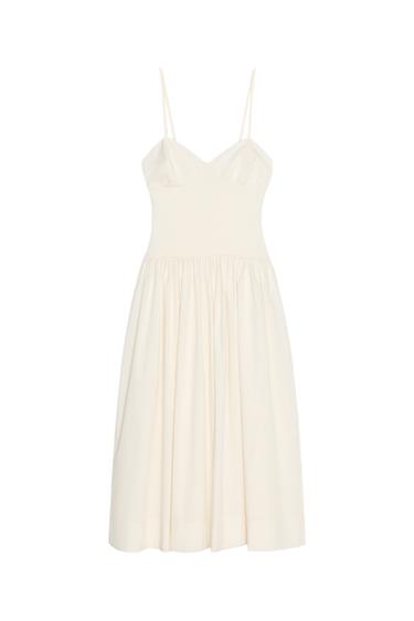Front view of a white dress with spaghetti straps and a pleated skirt.