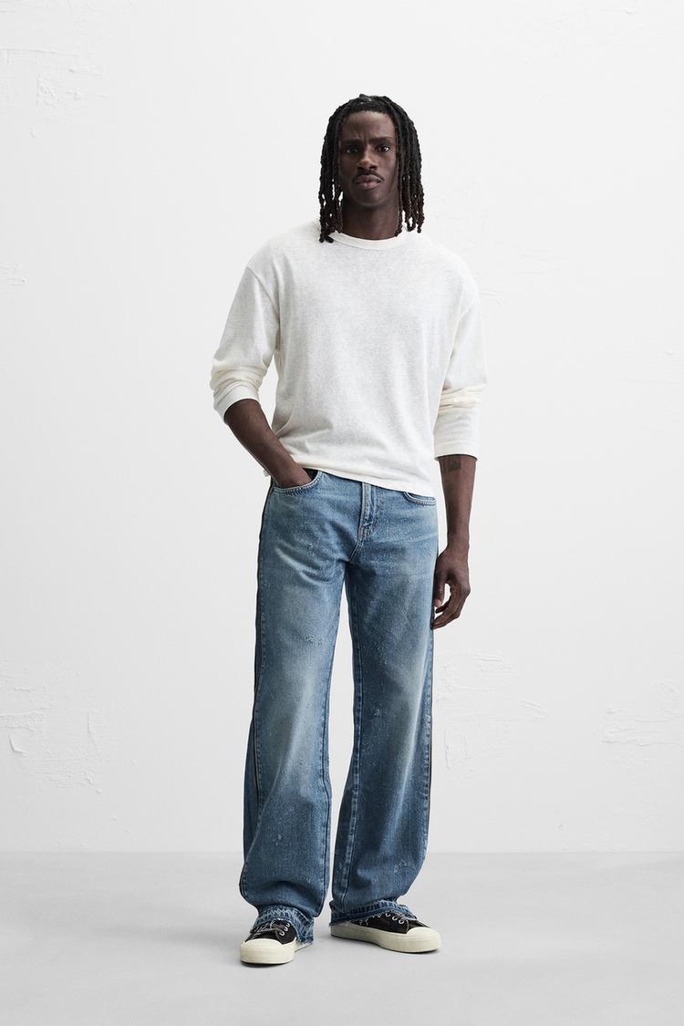 JEANS À BOCA DE SINO COM FECHOS DE CORRER