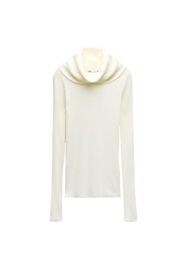 Front view of a white turtleneck sweater with long sleeves.