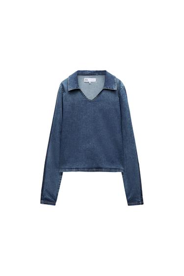 Blue denim V-neck long-sleeve shirt, white background. Visible tag on the collar.