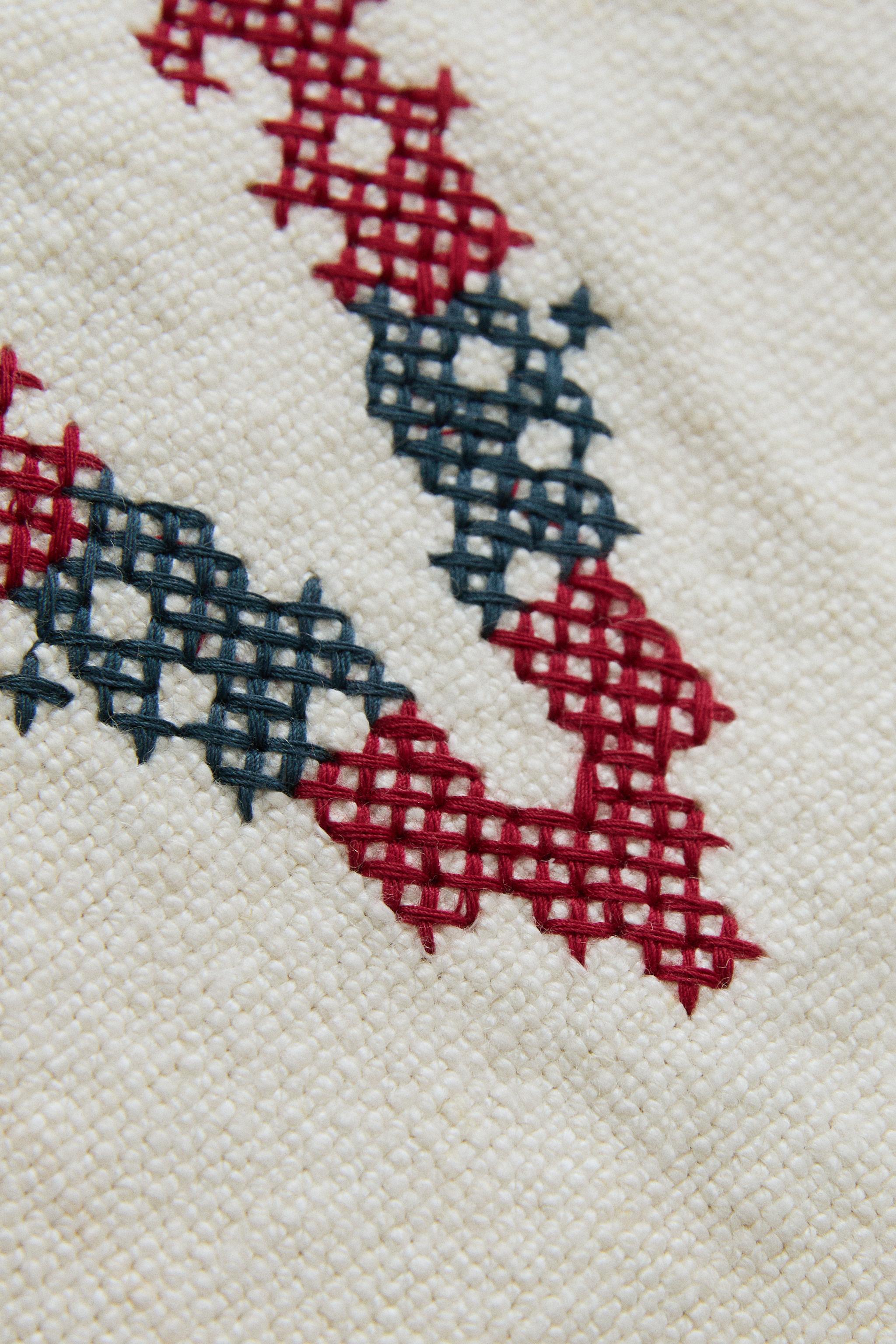 EMBROIDERED 'V' LETTER LINEN CUSHION — Ecru