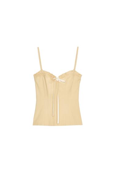 Front view of a fitted mustard top with spaghetti straps, sweetheart neckline, front tie and concealed side zip fastening.
