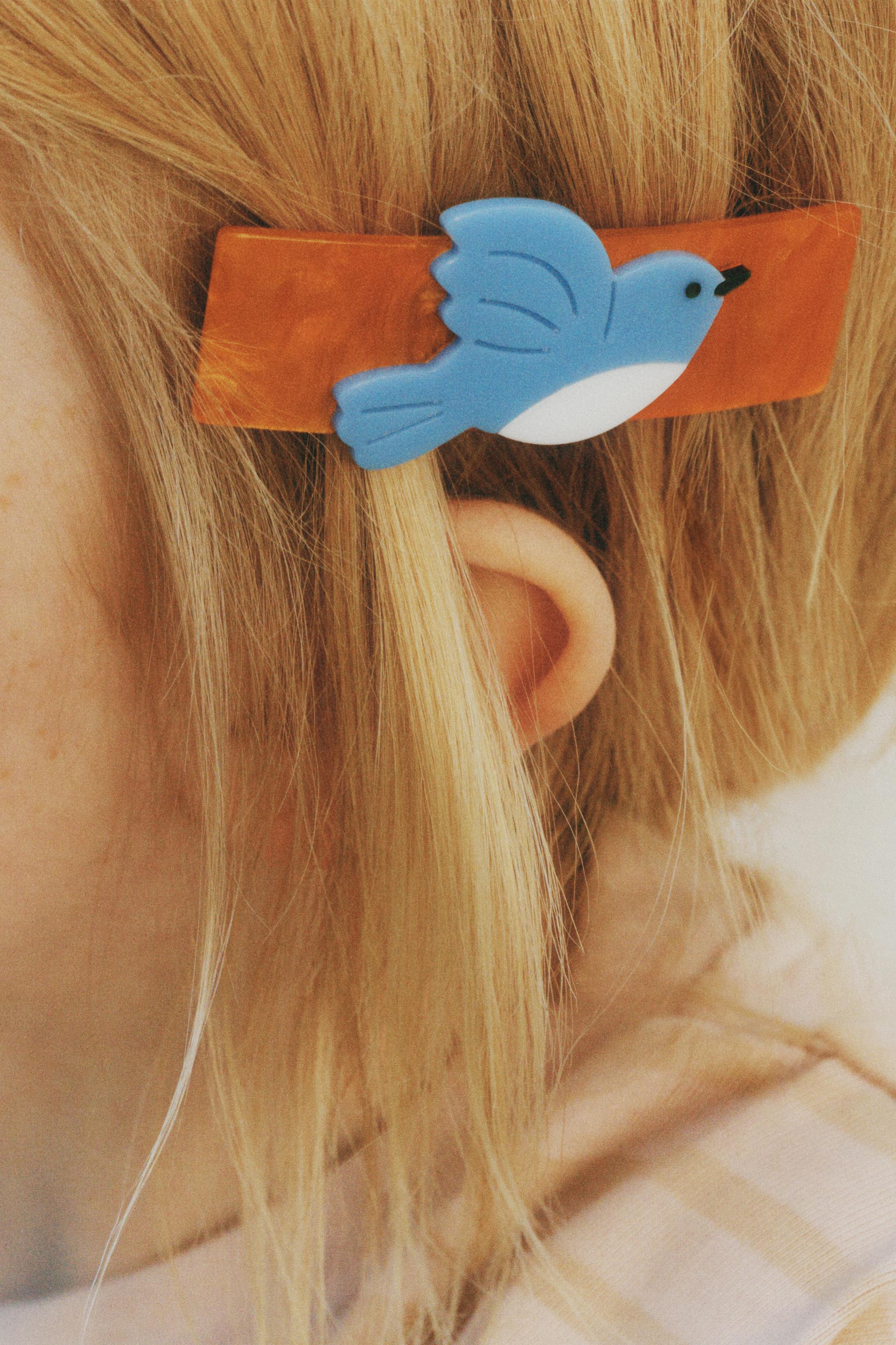 LOT DE DEUX BARRETTES À FLEURS ET OISEAU