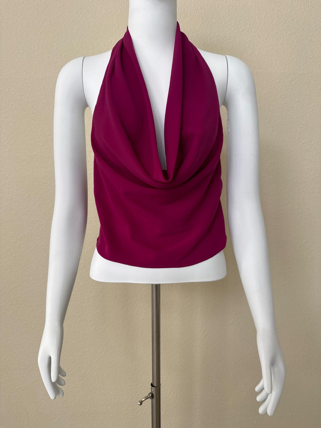 White mannequin with a magenta halter-neck, draped-bodice top against a beige background. Simple and minimalist style.