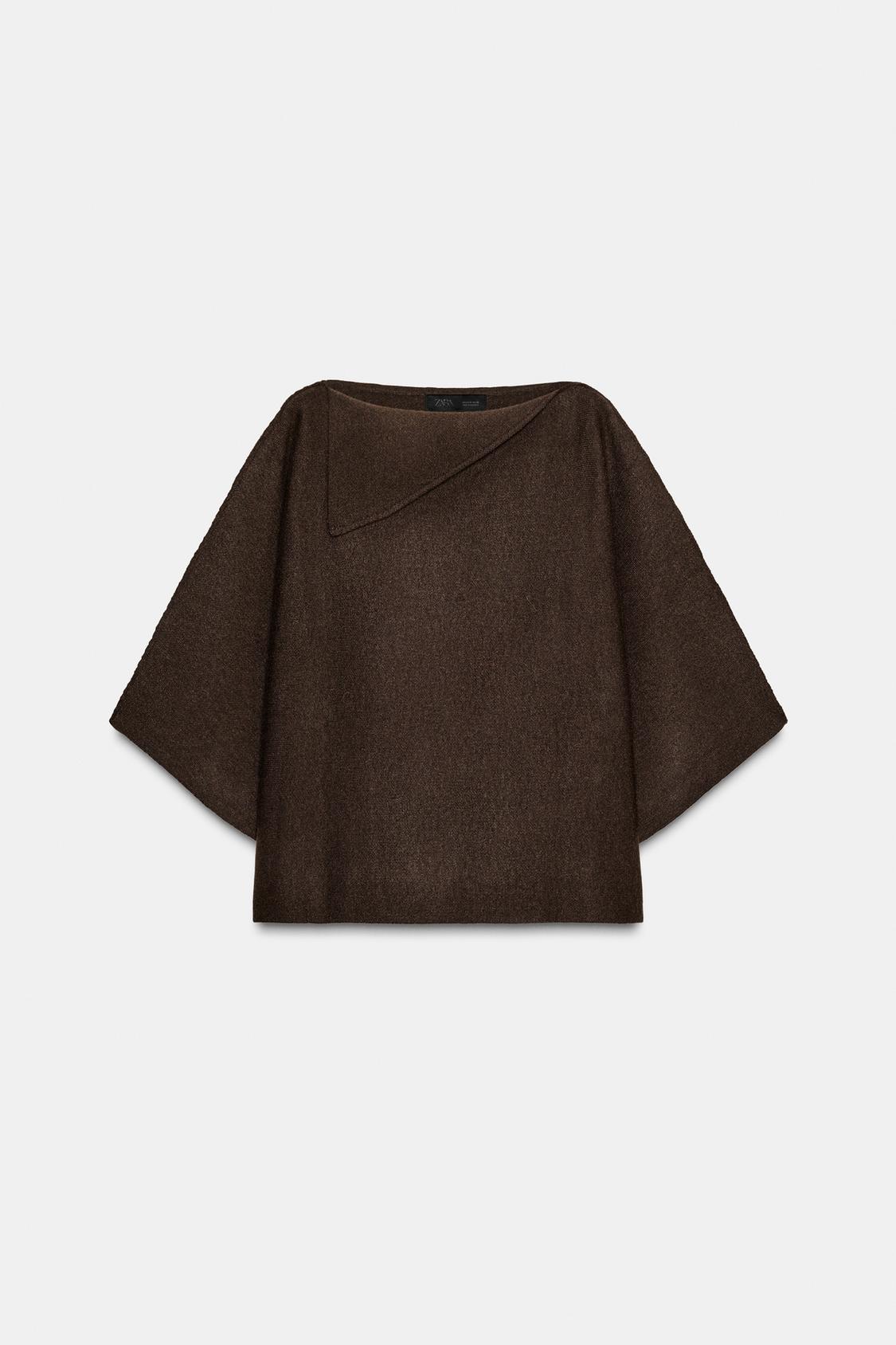 Front view of a brown knitted jumper with a boat neck and flap, wide three-quarter sleeves and regular hem.