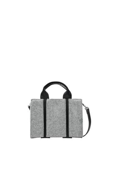 Gray bag with handles and black strap on white background. Rectangular design with black vertical line details.