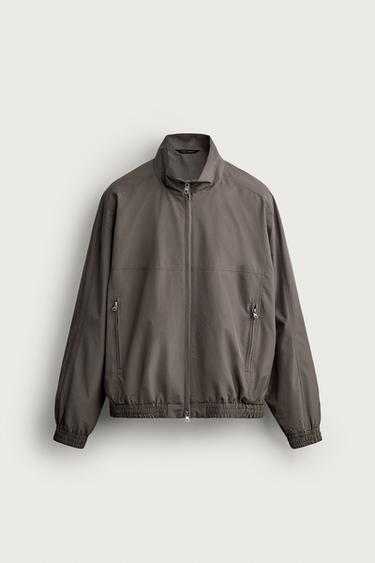 ЖЕҢІЛ СУ ӨТКІЗБЕЙТІН МАТЕРИАЛ ТЕХНИКАЛЫҚ КҮРТКЕ - Қоңыр Zara компаниясынан