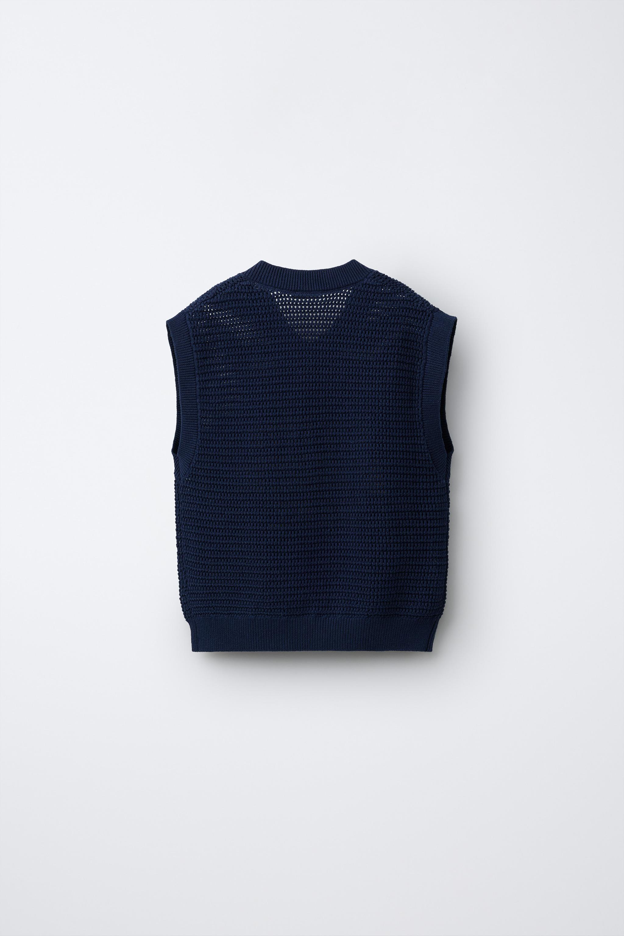 GILET EN MAILLE AVEC INSCRIPTION VELOURS BOUCLÉ