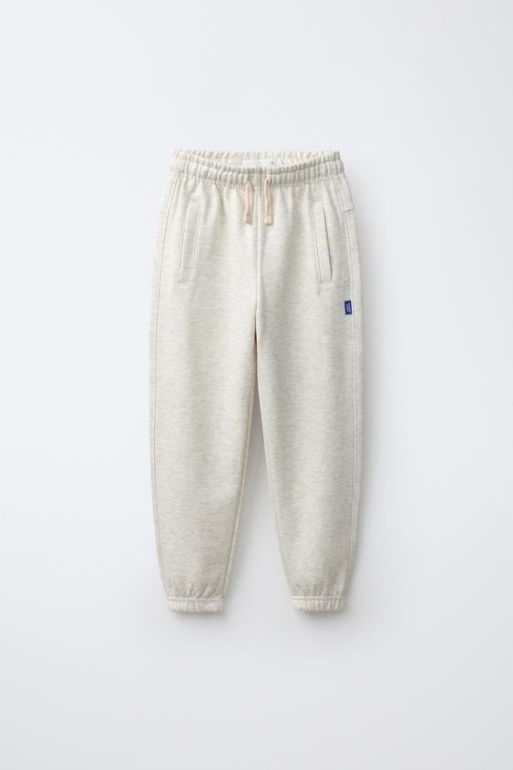 PANTALON DE JOGGING EN MOLLETON UNI AVEC ÉTIQUETTE - Écru / Chiné de Zara - Image 0