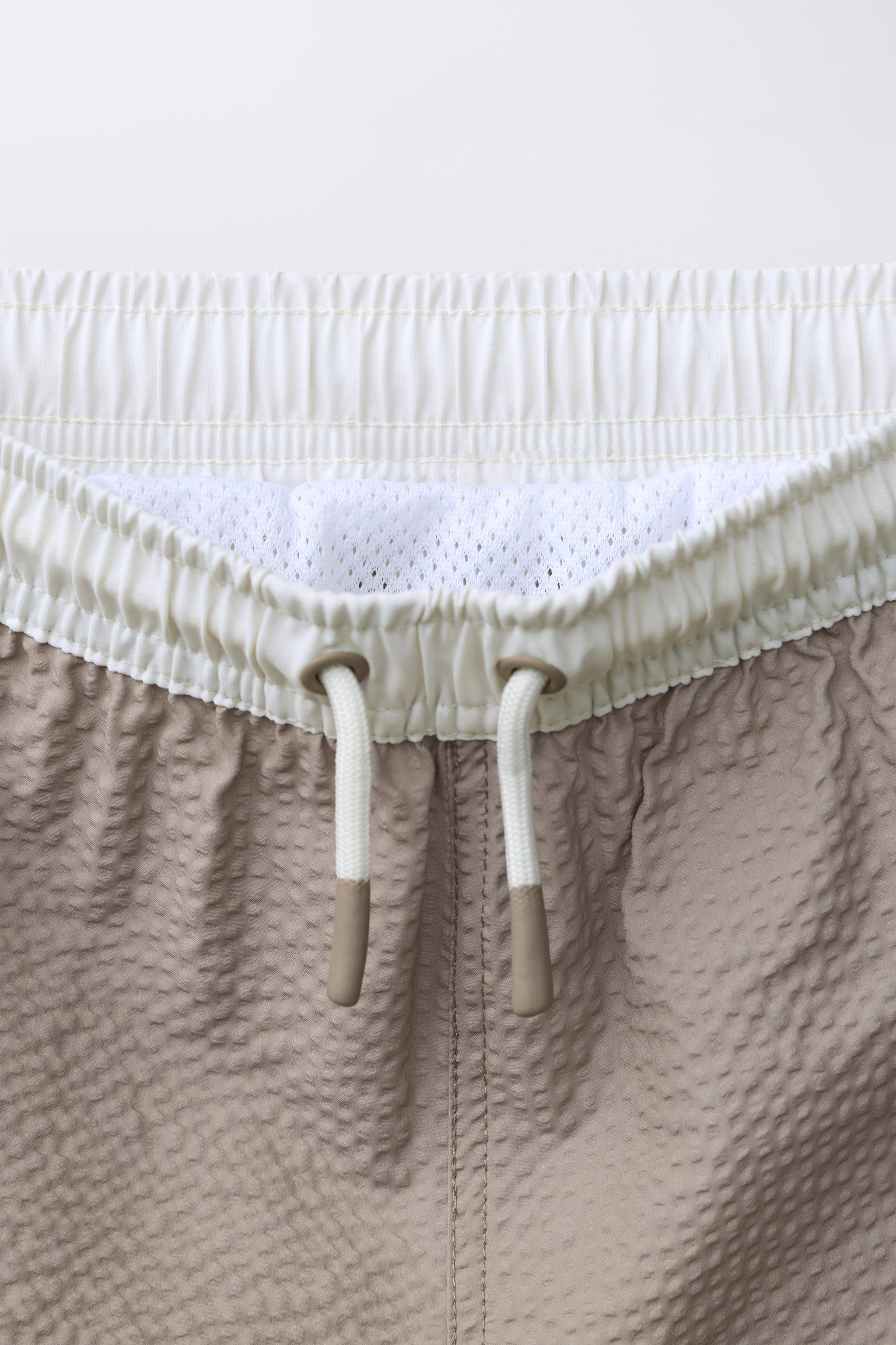 AGES 6-14 / LABEL SWIM SHORTS