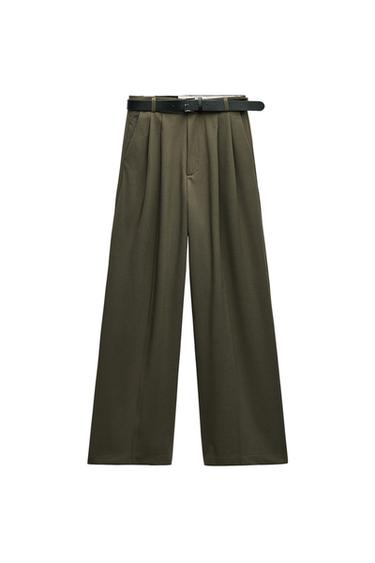 Front view of wide-leg olive green pants with black belt and side pockets