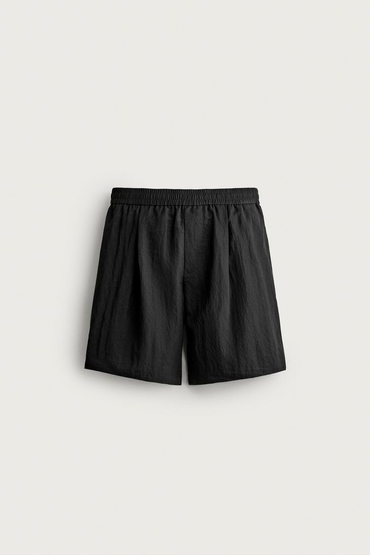 Bermuda relaxed fit fluida pliegues