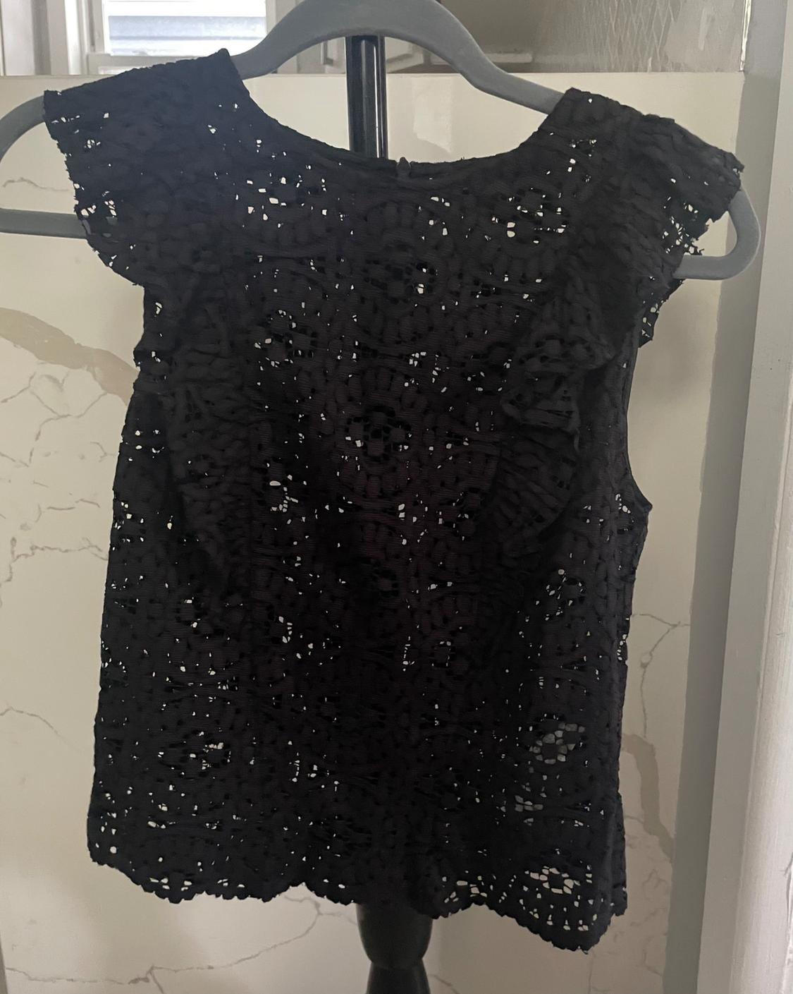 Front view of a black lace blouse with short sleeves