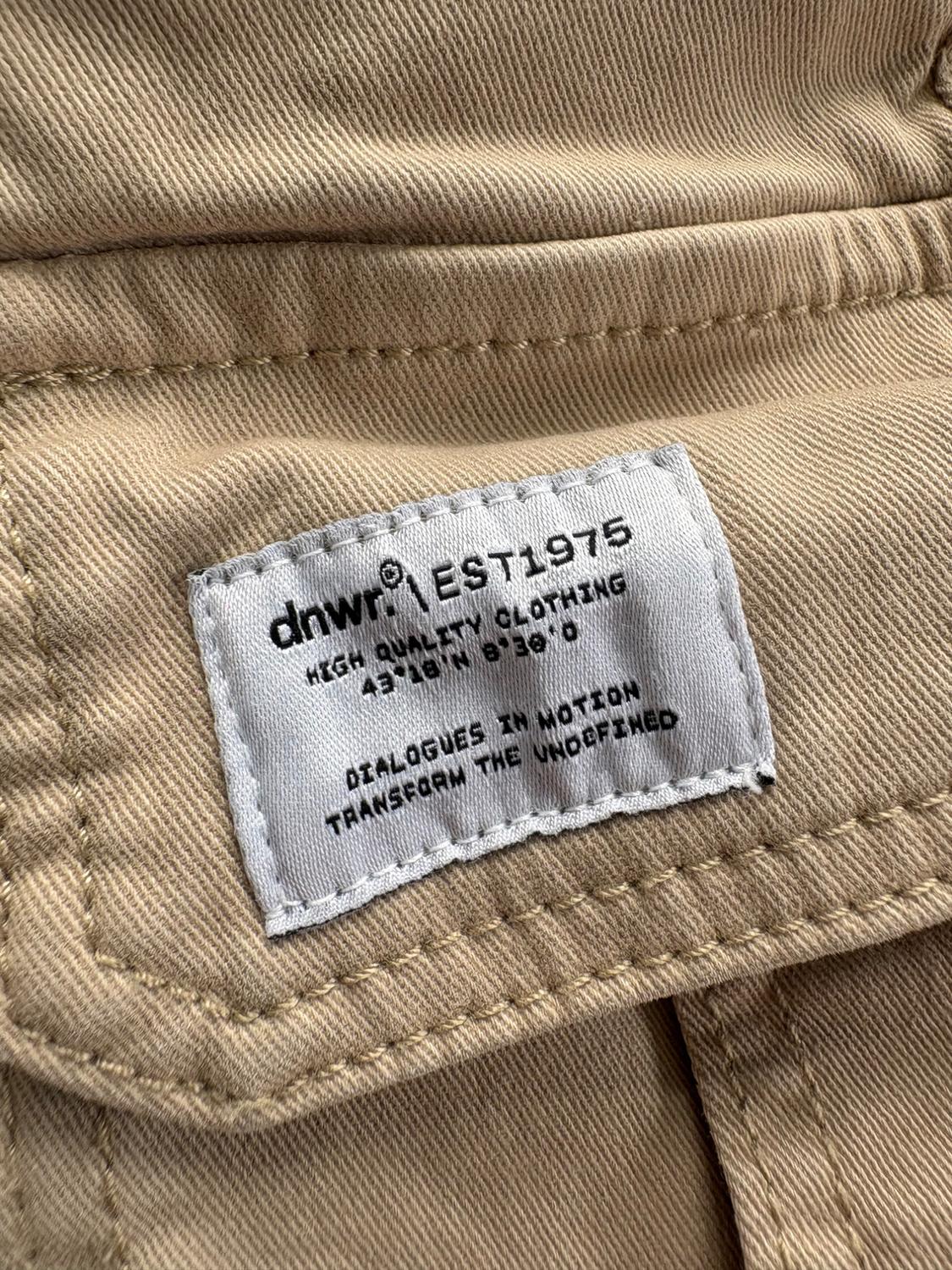Elastic waistband shorts. Front pockets and back flap pockets. Flap patch pockets at legs. Front zip and button closure. - Image 3