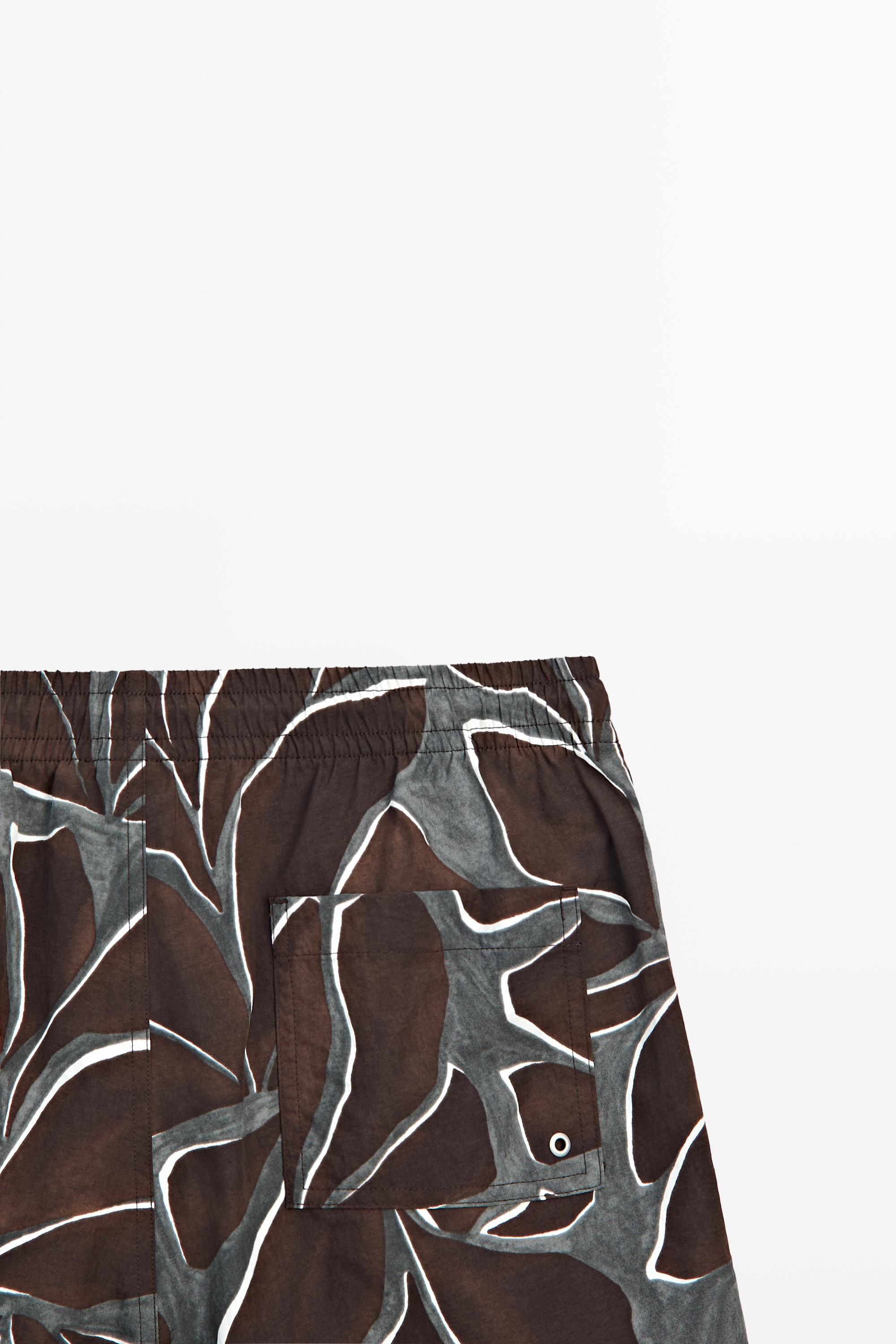 Tropical print swimming trunks