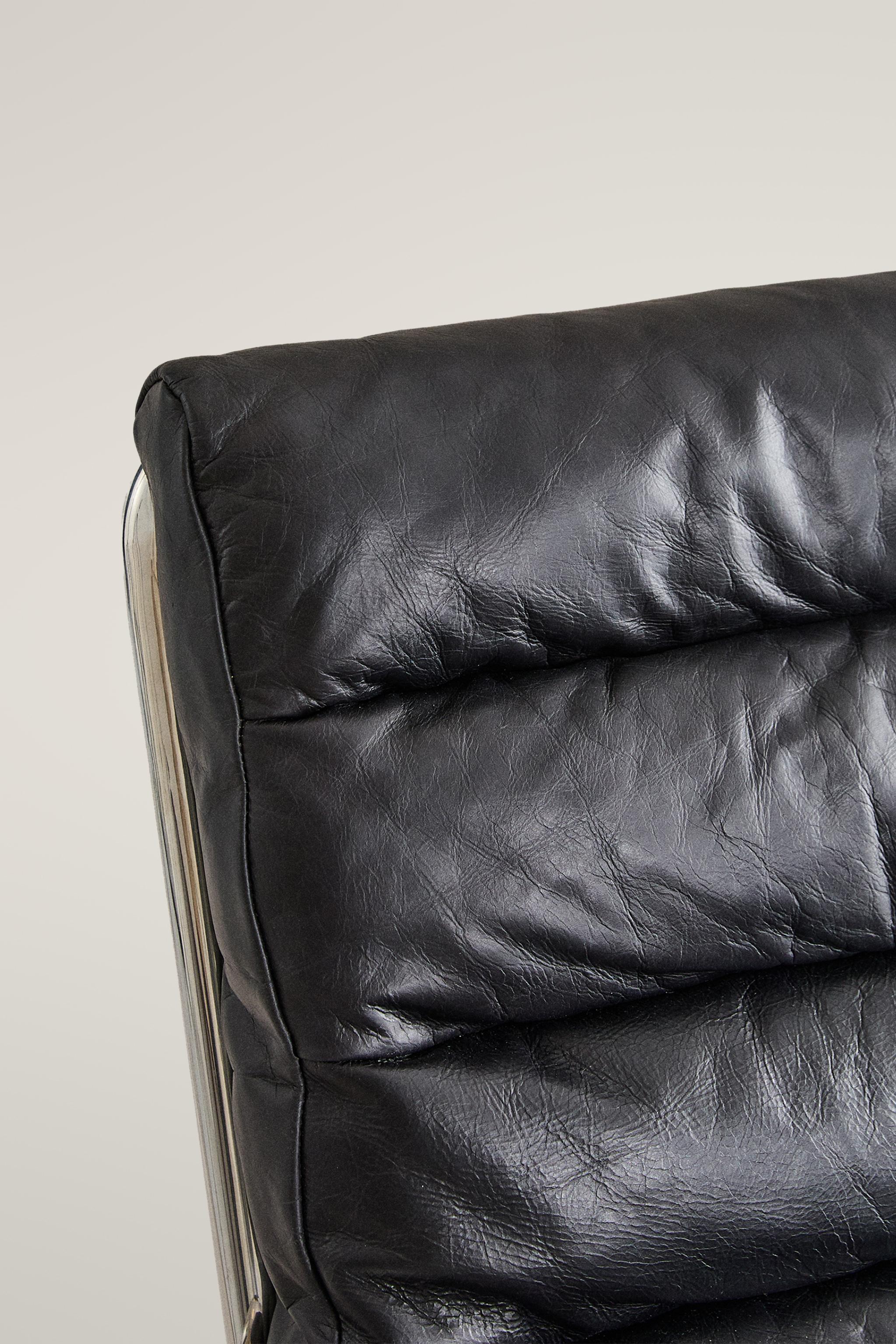 LEATHER AND STAINLESS STEEL ACCENT CHAIR