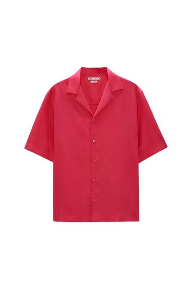 Short-sleeve shirt in fuchsia pink with a lapel collar and front button closure on a white background.