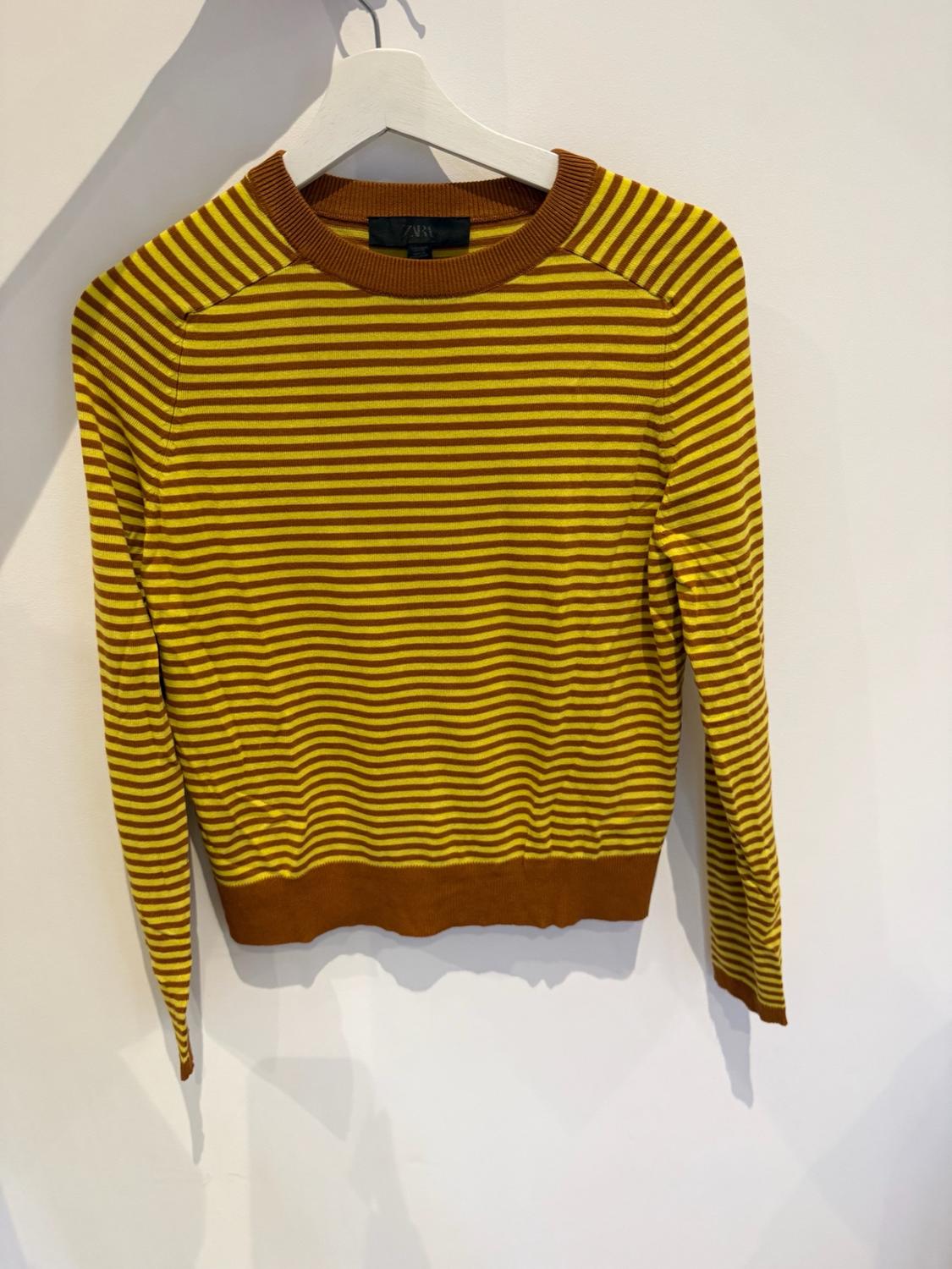 Long-sleeved knitted jumper with horizontal yellow and brown stripes on a white hanger against a white background. ZARA label.