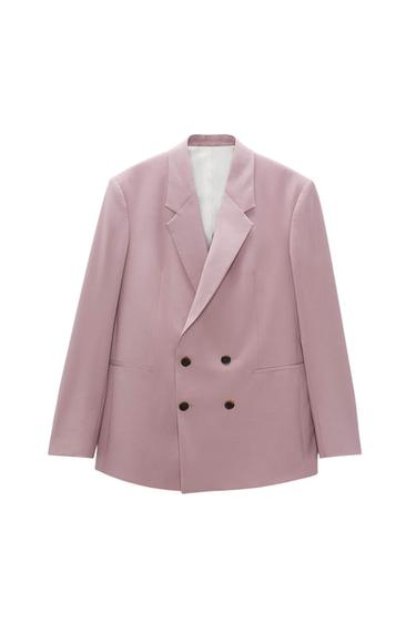 Light pink double-breasted blazer with wide lapels and front pockets, on a white background.