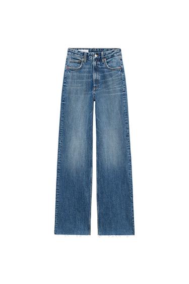 Front view of blue jeans with front pockets and frayed hems.