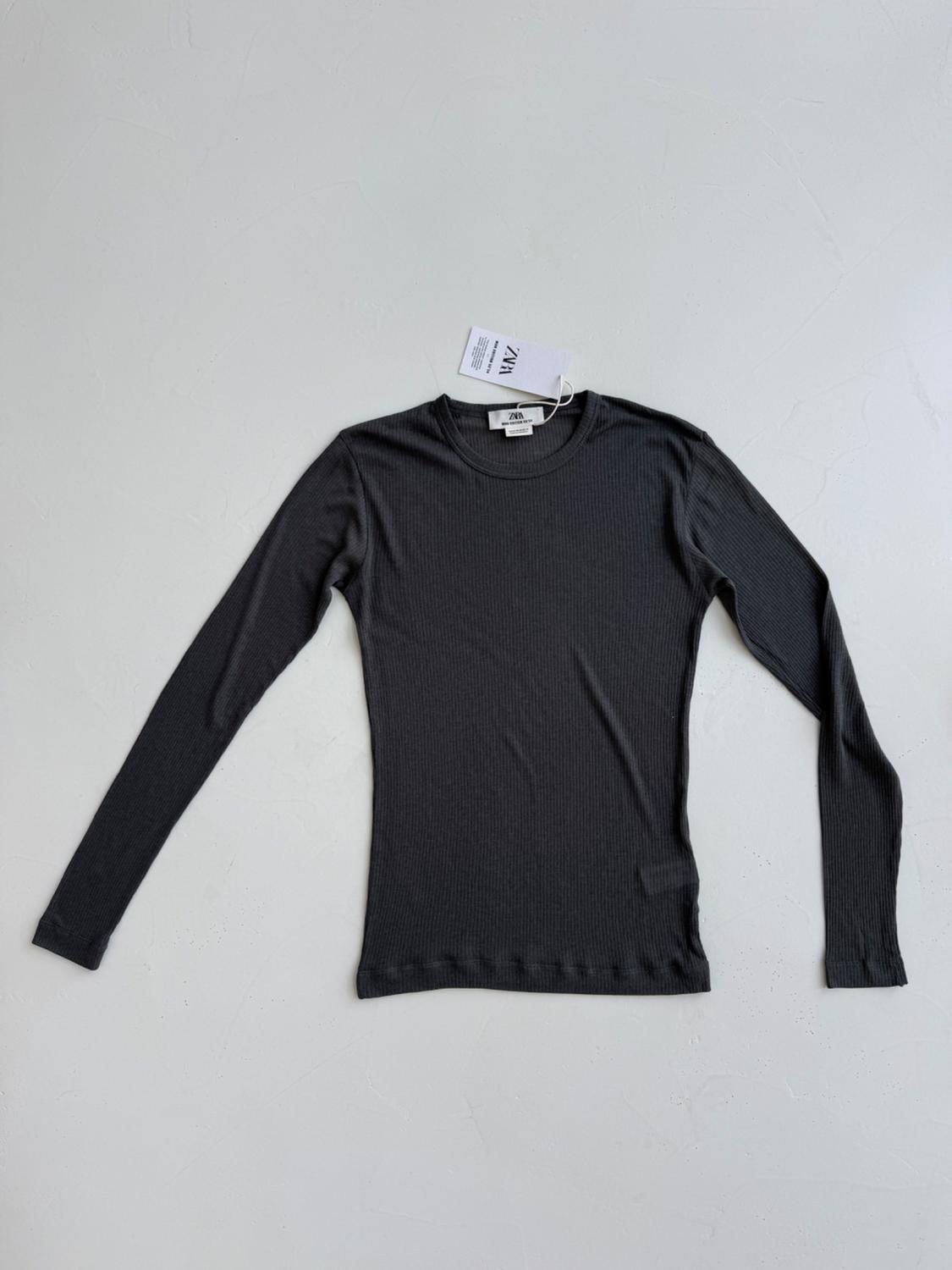 Black long-sleeved T-shirt on a white background, with a visible label that says "ZARA".