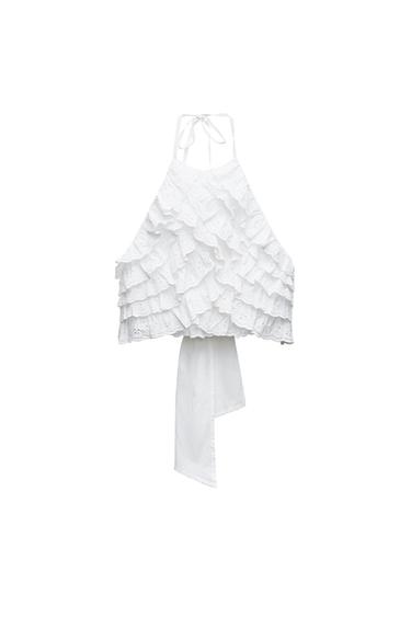 Front view of a white blouse with frills and a neck tie