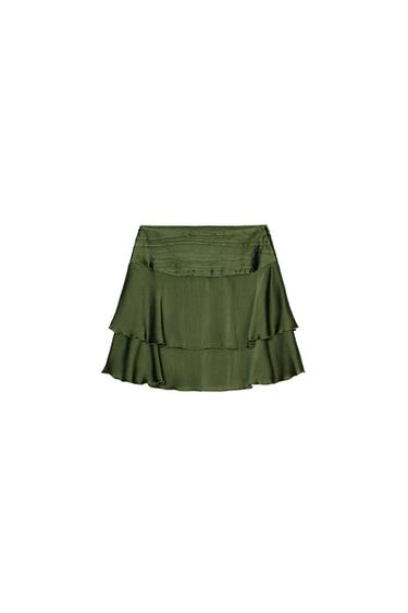 Front view of a dark olive satin mini skirt with ruffles and a concealed side zip fastening.