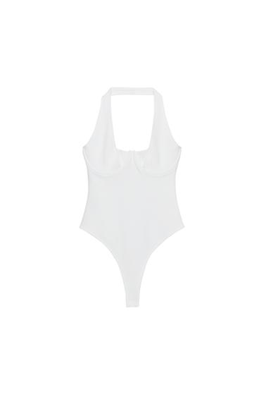Front view of a fitted white body with a halter neck, round neckline, and underwiring. Press-stud fastening at the bottom.